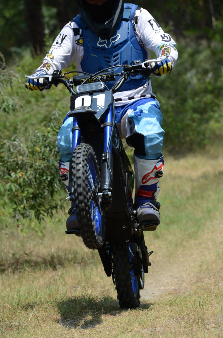 Evoltrix ROGUE MX-01 Off-Road Electric Dirt Bike, Rider Jumping on Grass & Dirt Trail