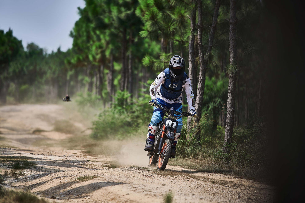 Evoltrix ROGUE MX-01 3000W Off-Road Electric Dirt Bike, Rider Riding on Pine Forest Dirt Trail